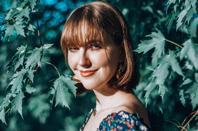 Portrait of beautiful young woman with leaves