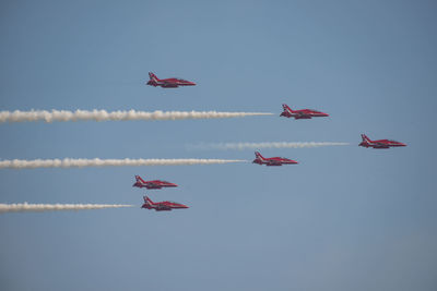 Low angle view of airshow against sky