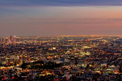 High angle view of illuminated city buildings against sky