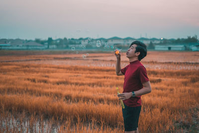 Full length of man standing on field