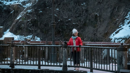 Rear view of man standing against rock