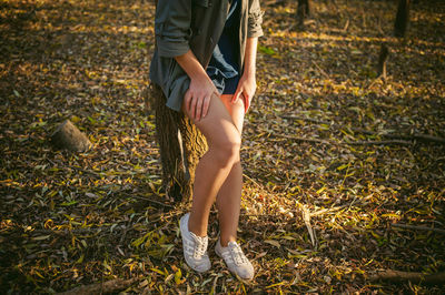 Low section of woman standing on grass