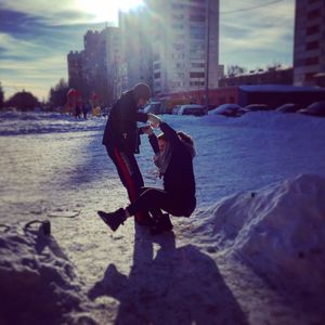 Side view of man photographing water in city