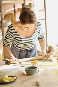 Midsection of man having food at home