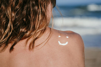 Rear view of woman at beach