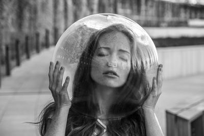 Young woman wearing glass helmet in head on sidewalk