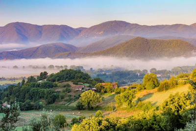 Scenic view of landscape and mountains against sky