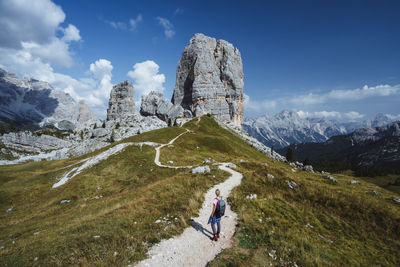 Rear view of person on mountain against sky