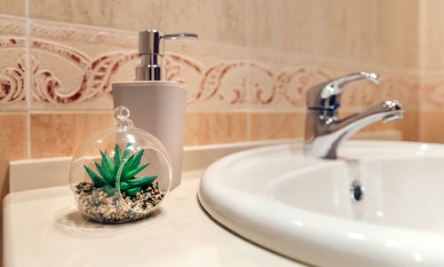Close-up of faucet in bathroom at home