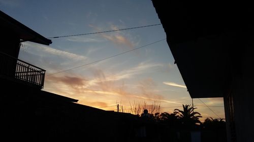 Low angle view of silhouette building against sky at sunset