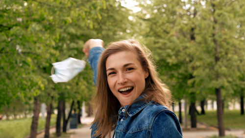 Portrait of smiling woman against plants