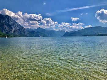 Scenic view of sea and mountains against sky