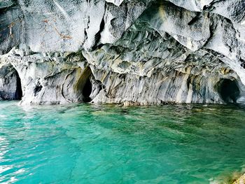 Scenic view of sea seen through cave