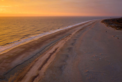 Scenic view of beach against sky during sunset