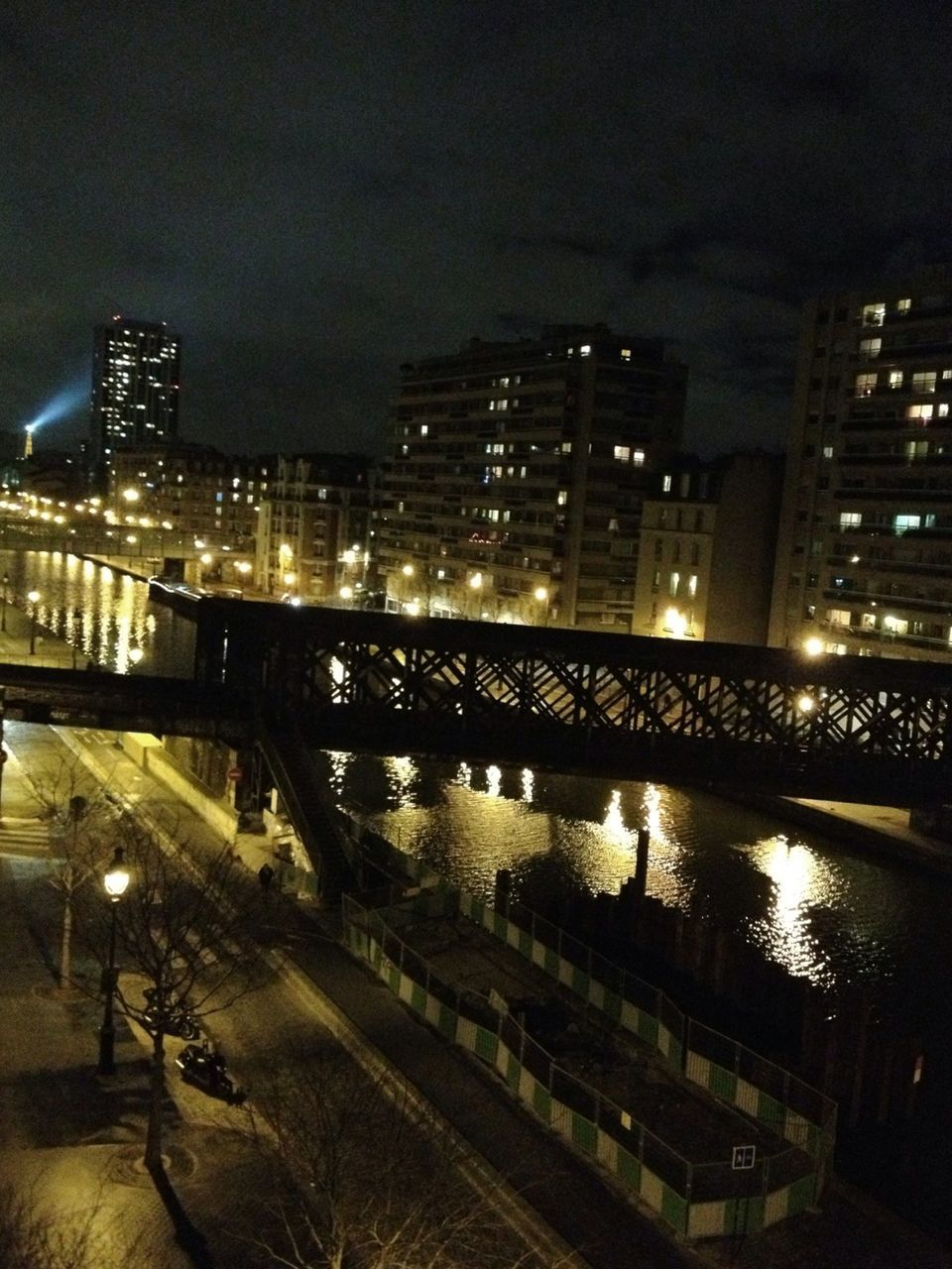 night, illuminated, architecture, built structure, city, building exterior, cityscape, skyscraper, river, modern, water, city life, reflection, urban skyline, bridge - man made structure, office building, tall - high, connection, sky, high angle view