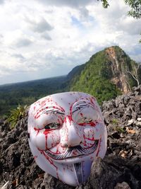 Close-up of sunglasses on mountain against sky