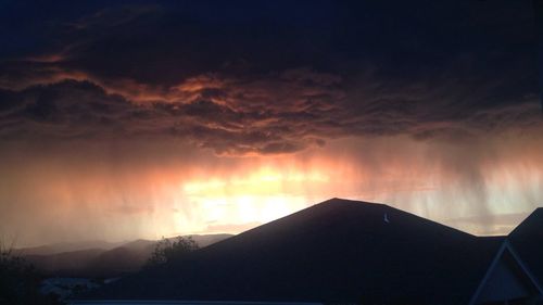 Scenic view of silhouette mountain against sky at sunset