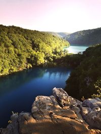 Scenic view of river and mountains against clear sky