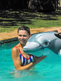 Portrait of smiling man in swimming pool