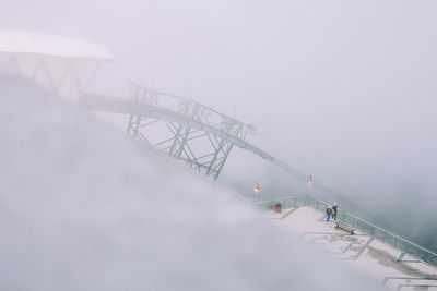 High angle view of people on bridge against sky during winter