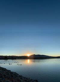 Scenic view of lake against sky during sunset