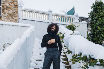 Full length of woman standing in snow