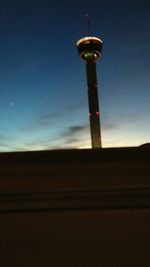 Low angle view of communications tower against sky at night