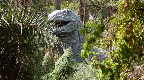 Representation of dinosaur amid plants