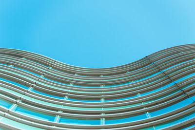 Low angle view of modern building against clear blue sky