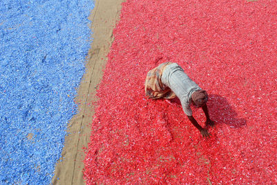 High angle view of a man working with colorful plastics
