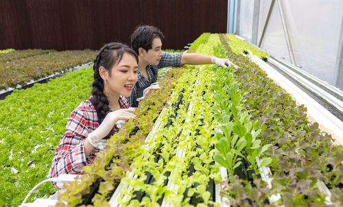 Young woman standing amidst plants