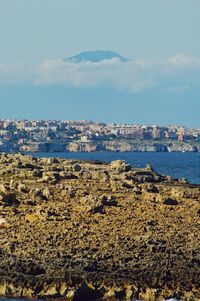 Scenic view of sea and buildings against sky
