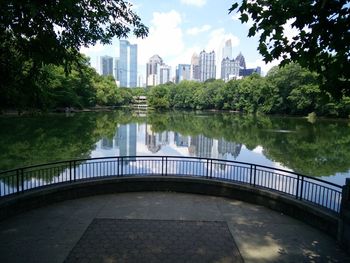 View of lake by buildings against sky