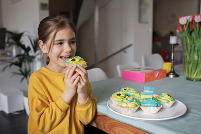 Portrait of young woman eating food