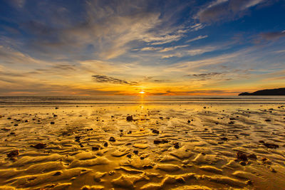 Scenic view of beach against sky during sunset