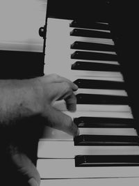 Close-up of man playing piano