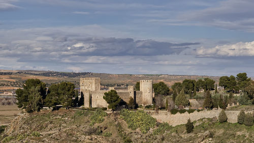 View of castle against cloudy sky