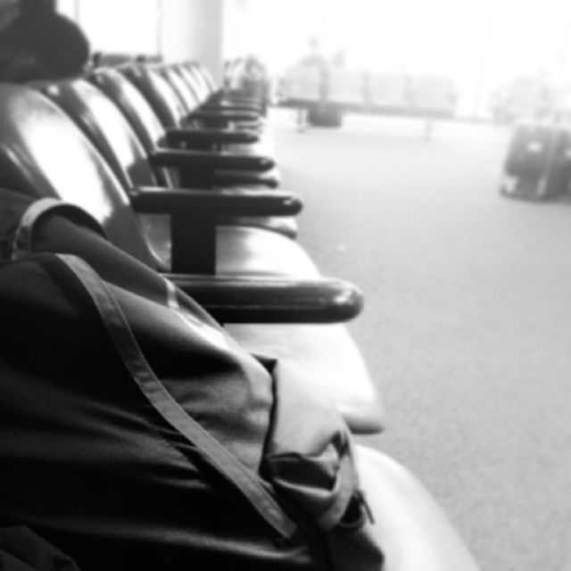 focus on foreground, close-up, indoors, selective focus, in a row, part of, metal, day, low section, sunlight, seat, one person, shoe, cropped, absence, music, detail, empty