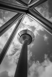 Low angle view of communications tower against sky