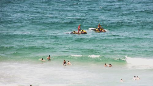 High angle view of people enjoying in sea