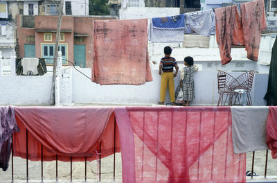 Rear view of children standing on building terrace