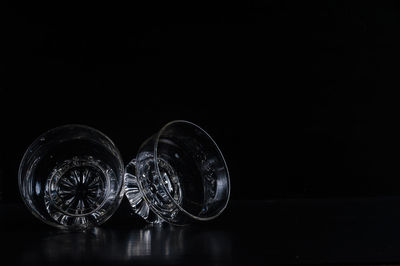 Close-up of glass bowls against black background