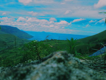 Scenic view of sea and mountains against sky
