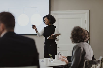 Businesswoman explaining in meeting at corporate office