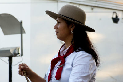 Close-up of woman in uniform and hat looking away outdoors