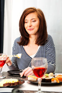 Young woman with drink on table