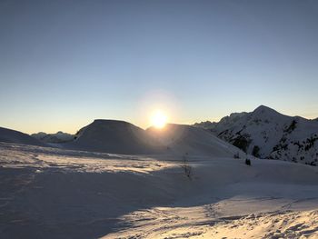 Scenic view of snowcapped mountains against clear sky