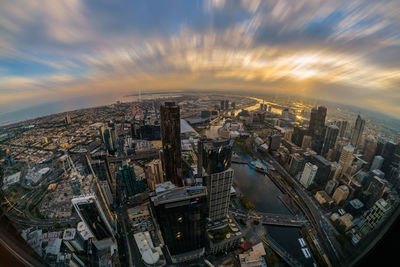 Aerial view of illuminated cityscape against sky at dusk