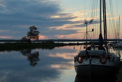 View of boats in lake at sunset