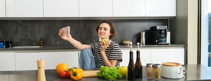 Portrait of young woman sitting at home